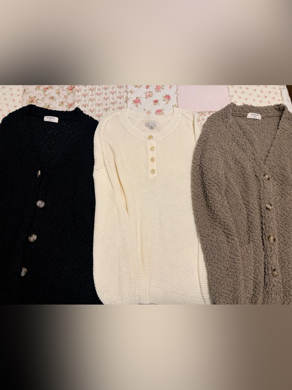 Set of three cardigans. Cream, black, and brown.